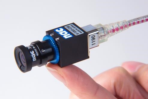 Micro-Cam camera head resting on finger tip